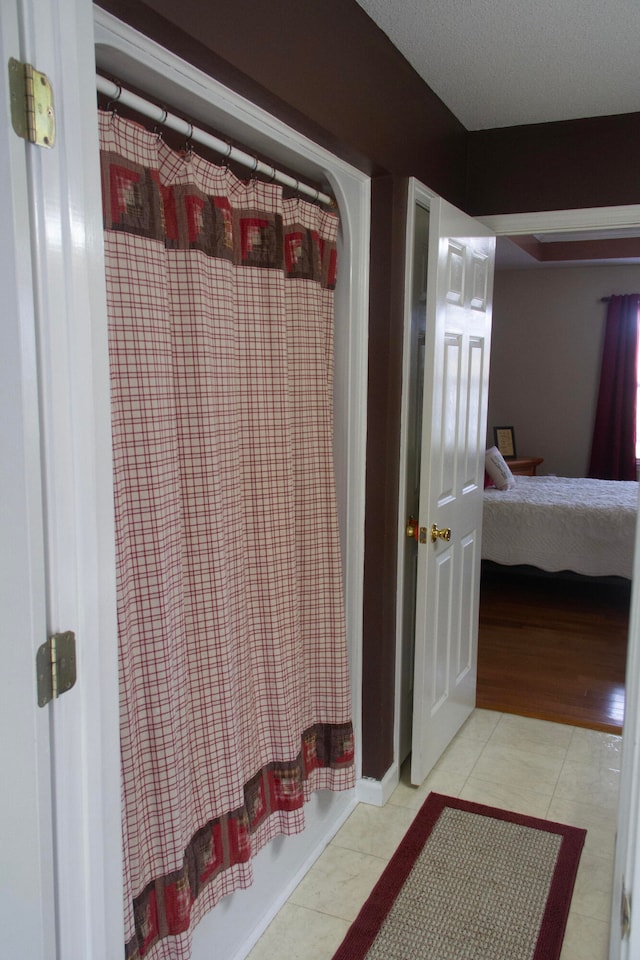 bathroom with tile patterned flooring and curtained shower