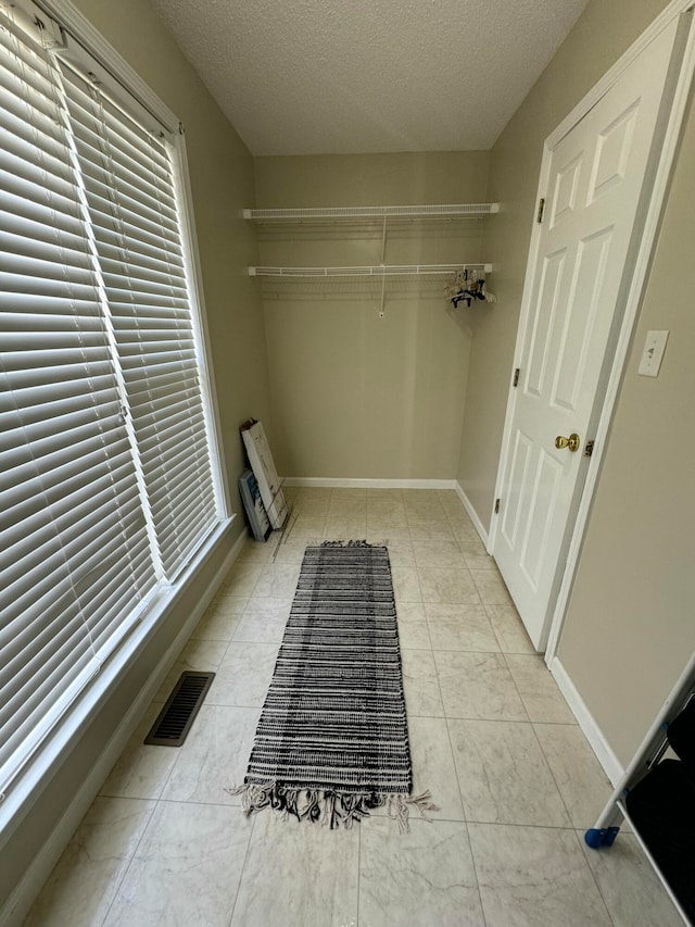 laundry area with a textured ceiling