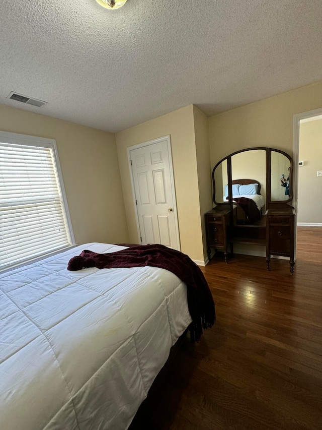 bedroom featuring wood-type flooring and a textured ceiling