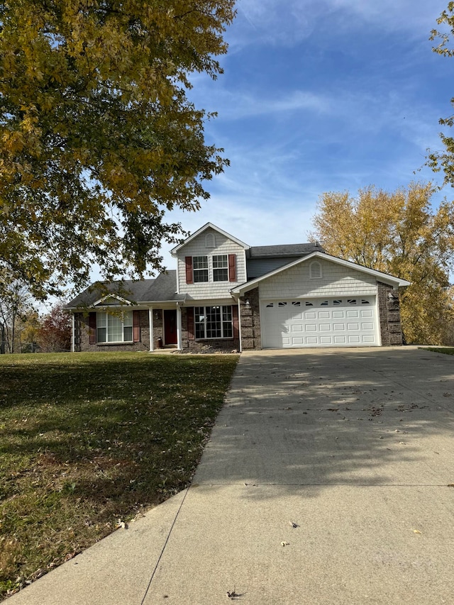 view of front of home featuring a garage and a front lawn