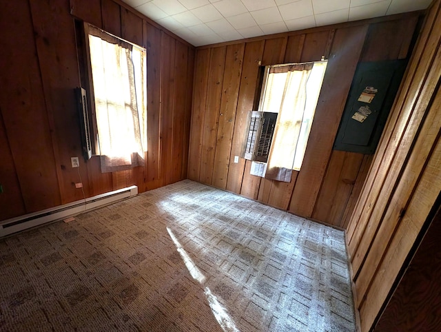 empty room with wooden walls and a baseboard radiator