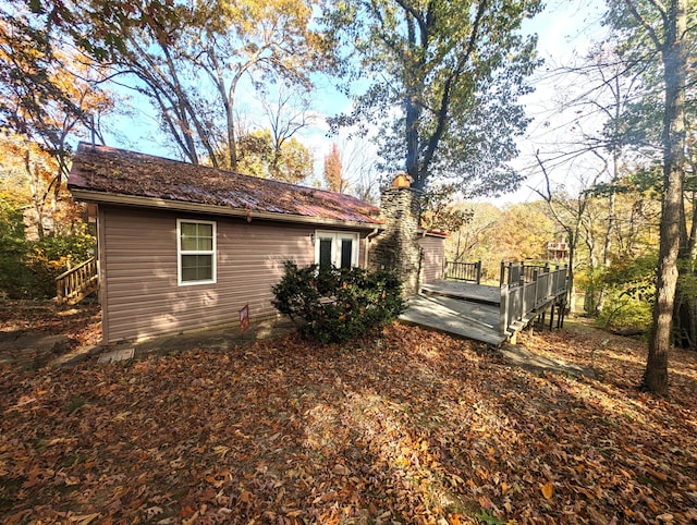 view of side of home featuring a wooden deck