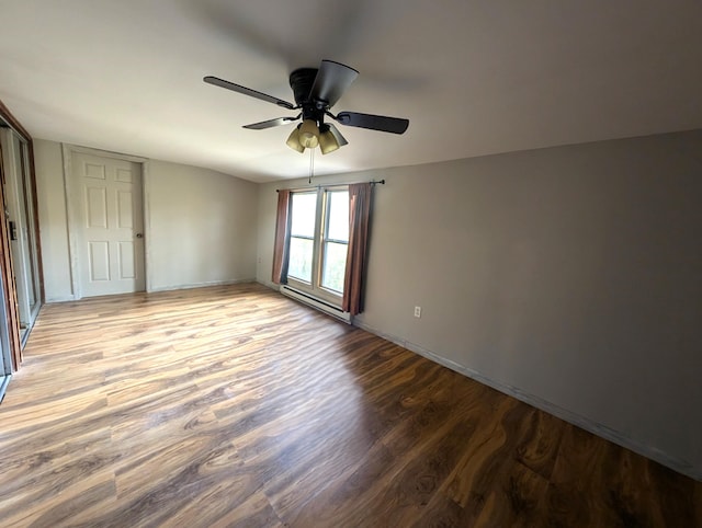 unfurnished room with light hardwood / wood-style flooring, a baseboard heating unit, and ceiling fan