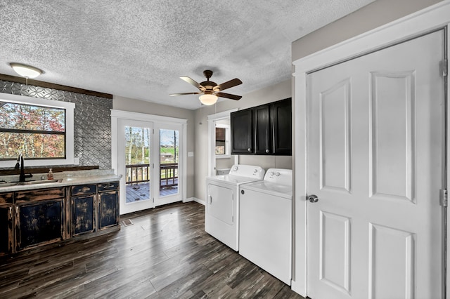 laundry room featuring cabinets, dark hardwood / wood-style floors, sink, and washing machine and dryer