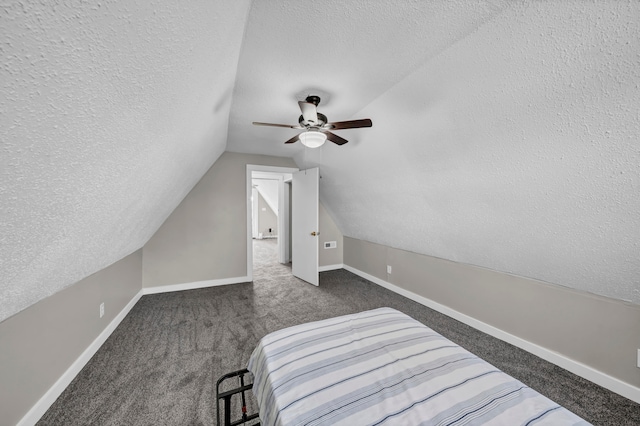 carpeted bedroom with a textured ceiling and ceiling fan