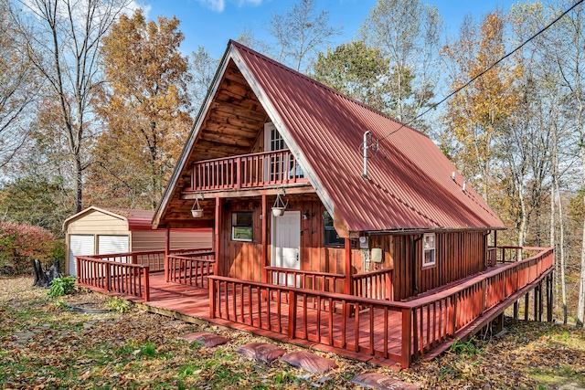 rear view of property featuring a deck