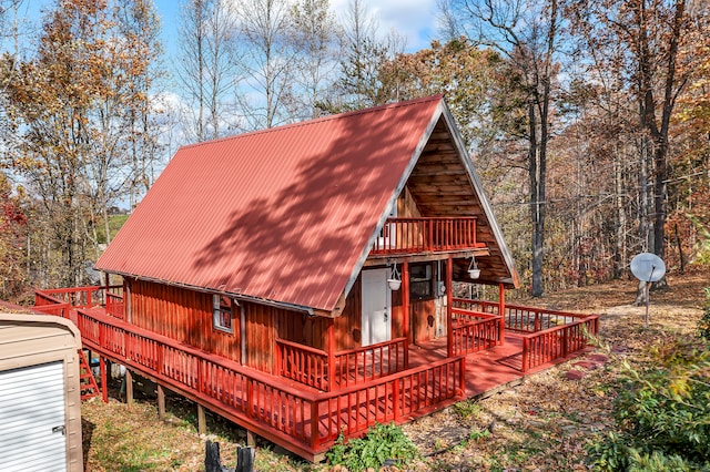 back of house with a deck