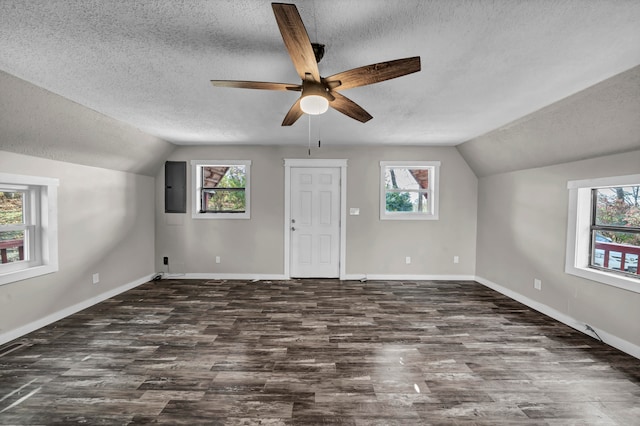 bonus room with a textured ceiling, a wealth of natural light, and vaulted ceiling