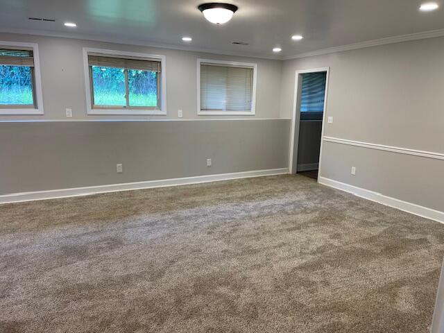 carpeted spare room with crown molding