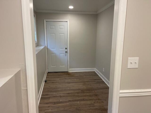 hall featuring ornamental molding and dark hardwood / wood-style floors