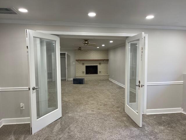 interior space featuring ornamental molding, french doors, and carpet flooring