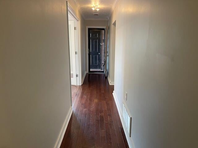 hallway featuring ornamental molding and dark hardwood / wood-style flooring