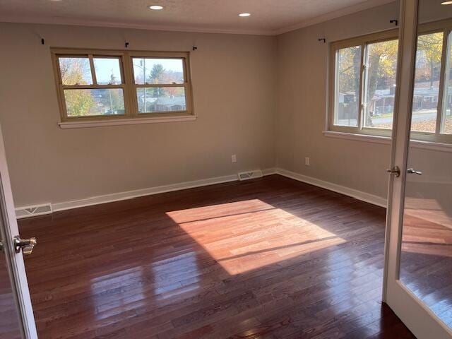 empty room with crown molding and dark hardwood / wood-style flooring