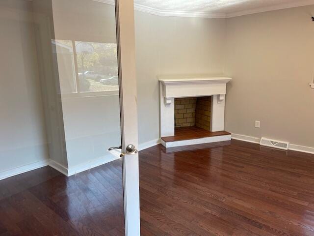 unfurnished living room with crown molding and dark hardwood / wood-style floors