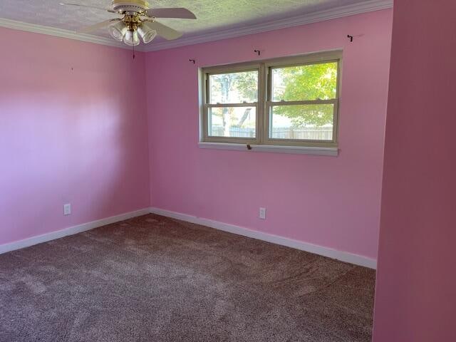 empty room with ceiling fan, crown molding, a textured ceiling, and carpet floors