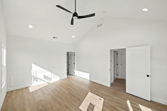 spare room with ceiling fan, high vaulted ceiling, and light hardwood / wood-style floors