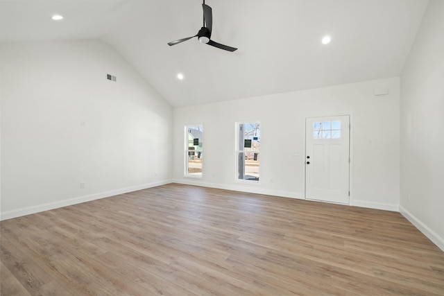 unfurnished living room featuring ceiling fan, high vaulted ceiling, and light wood-type flooring