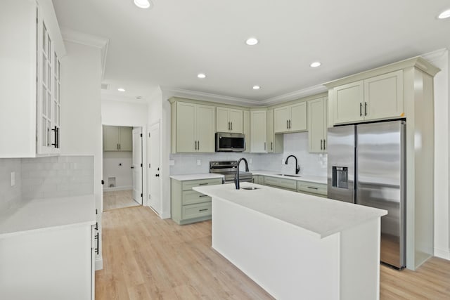 kitchen featuring sink, crown molding, light hardwood / wood-style flooring, backsplash, and stainless steel appliances