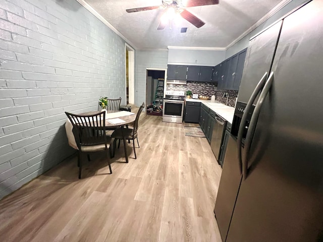 kitchen featuring crown molding, sink, light hardwood / wood-style flooring, and stainless steel appliances