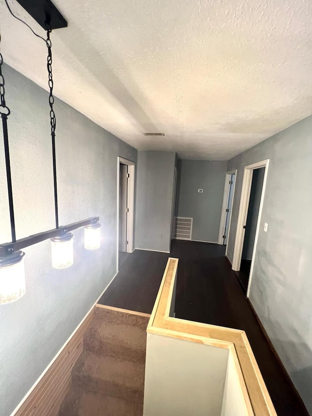 interior space featuring hardwood / wood-style flooring and a textured ceiling