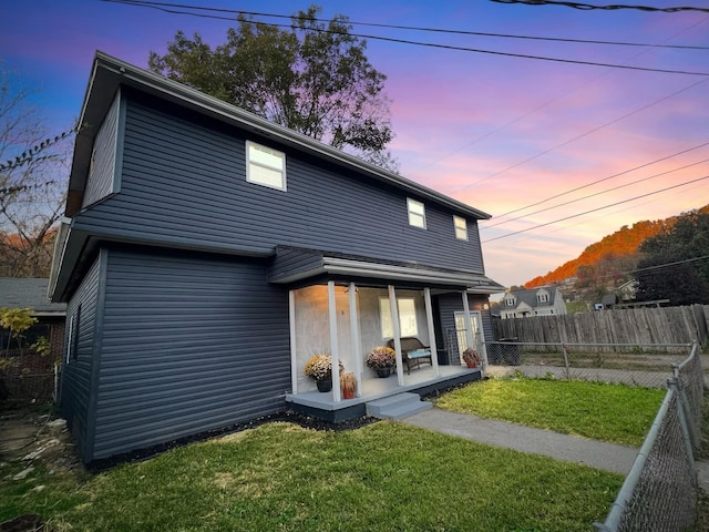 back house at dusk with a yard