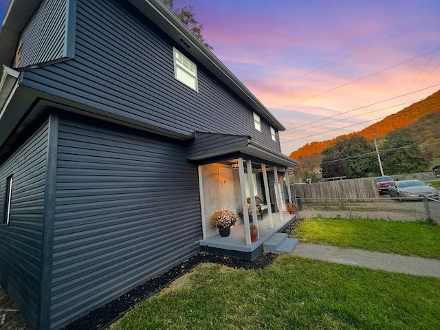 property exterior at dusk with a yard