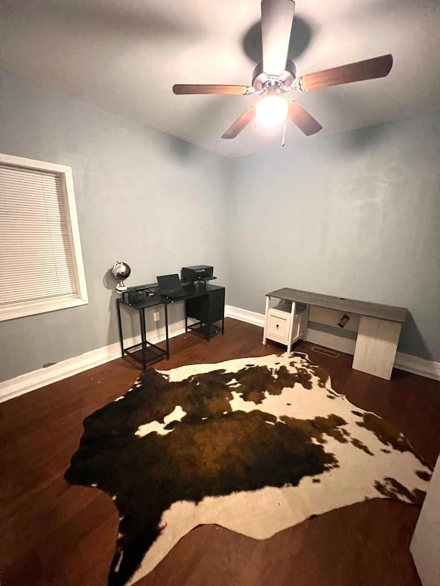 interior space with dark wood-type flooring and ceiling fan