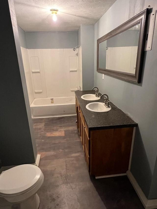 full bathroom featuring toilet, bathtub / shower combination, hardwood / wood-style floors, vanity, and a textured ceiling