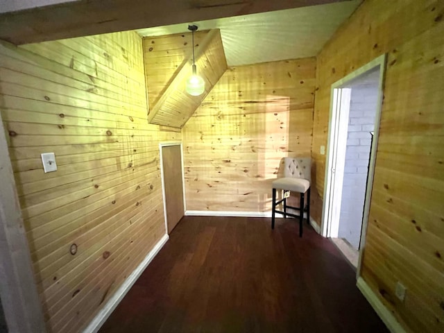 bonus room featuring lofted ceiling, dark hardwood / wood-style floors, and wood walls