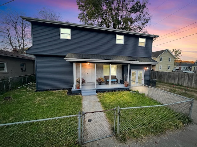 front of property featuring covered porch and a lawn