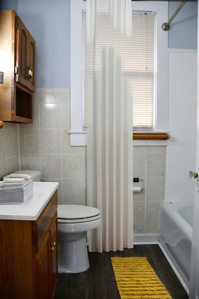 full bathroom with vanity, shower with separate bathtub, wood-type flooring, and toilet