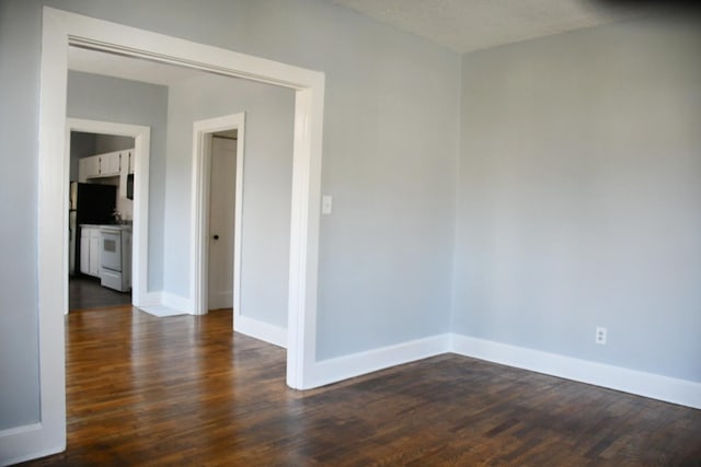 unfurnished room featuring a textured ceiling and dark hardwood / wood-style flooring