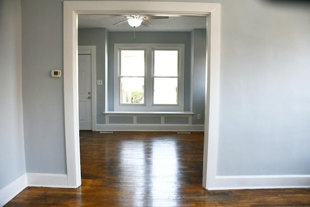 unfurnished room with ceiling fan and dark hardwood / wood-style flooring