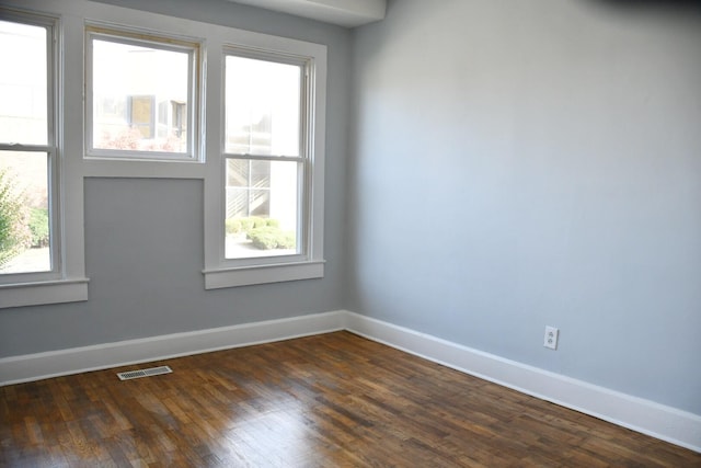 empty room with dark hardwood / wood-style floors