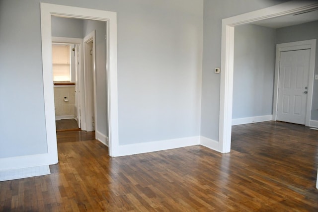 unfurnished room with dark hardwood / wood-style flooring