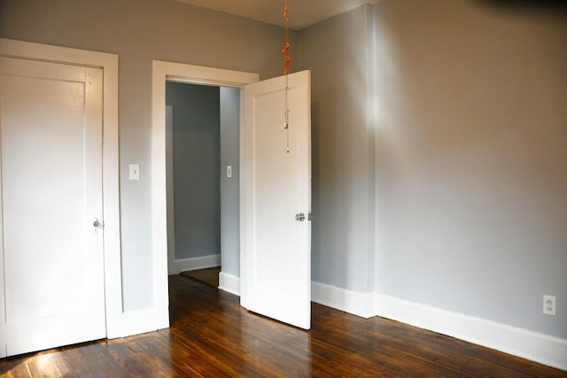 unfurnished bedroom featuring dark hardwood / wood-style floors