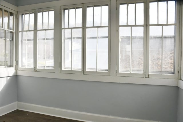 unfurnished sunroom featuring a water view