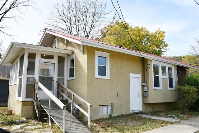 view of front of house with a sunroom