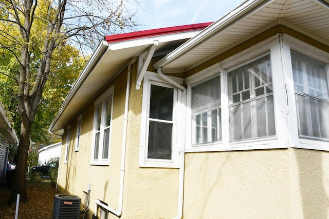 view of side of property with central air condition unit