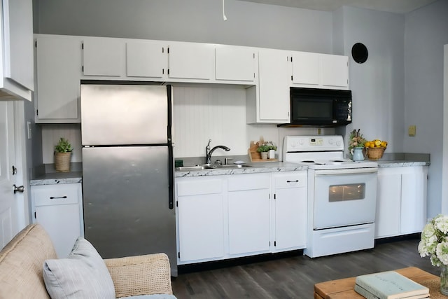 kitchen with sink, electric stove, dark hardwood / wood-style flooring, stainless steel fridge, and white cabinets