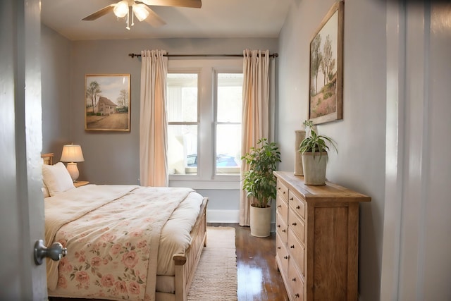 bedroom with dark wood-type flooring and ceiling fan