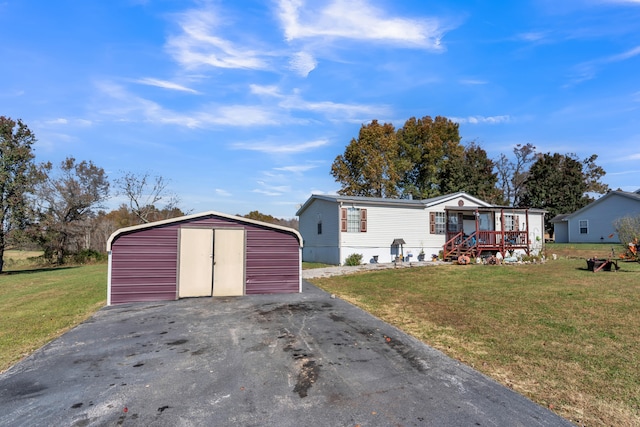 manufactured / mobile home with a storage shed and a front lawn