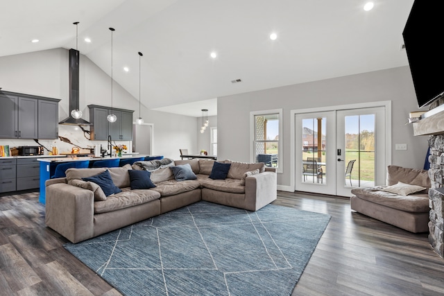 living room featuring dark hardwood / wood-style flooring, high vaulted ceiling, and french doors