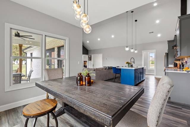 dining space featuring visible vents, baseboards, vaulted ceiling, and dark wood-style flooring