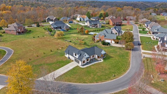 aerial view featuring a forest view and a residential view