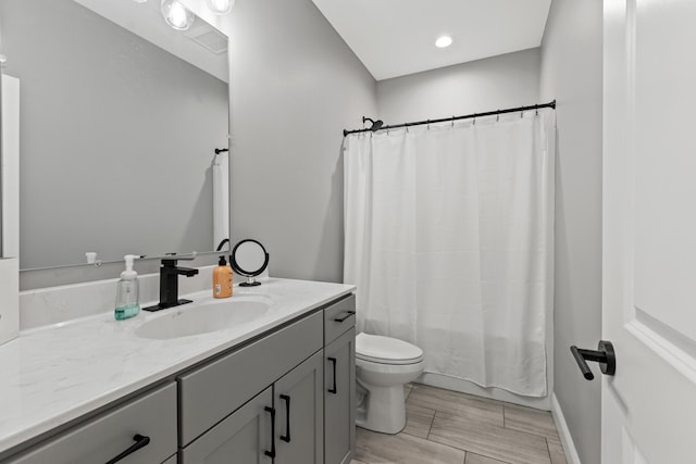 full bathroom with vanity, toilet, and shower / tub combo