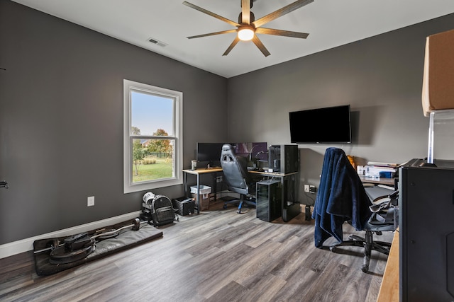 office with ceiling fan, wood finished floors, visible vents, and baseboards