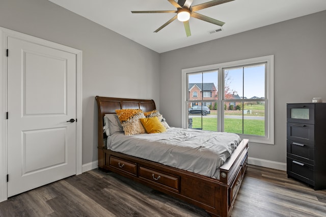 bedroom with ceiling fan and dark hardwood / wood-style flooring