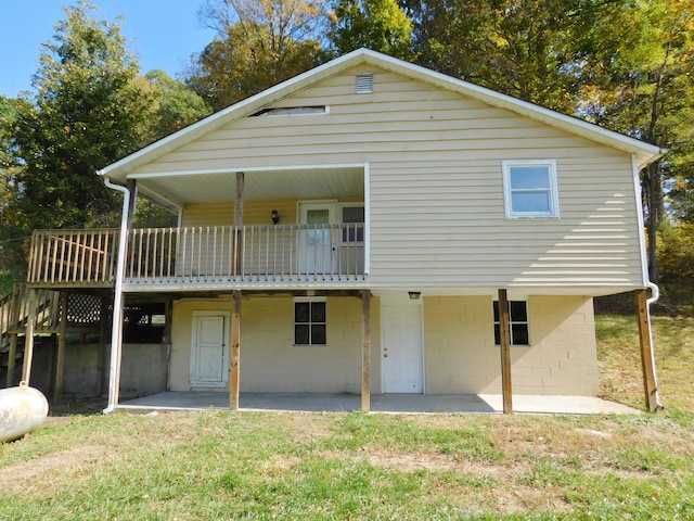 rear view of property with a patio, a deck, and a yard