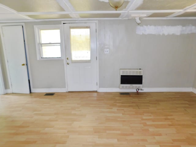 entrance foyer with coffered ceiling, heating unit, and light wood-type flooring